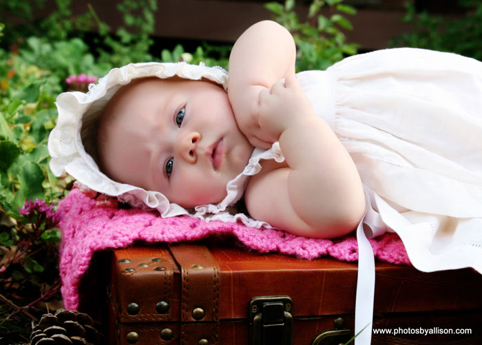 baby_laying_on_pink_blanket_suitcase.jpg