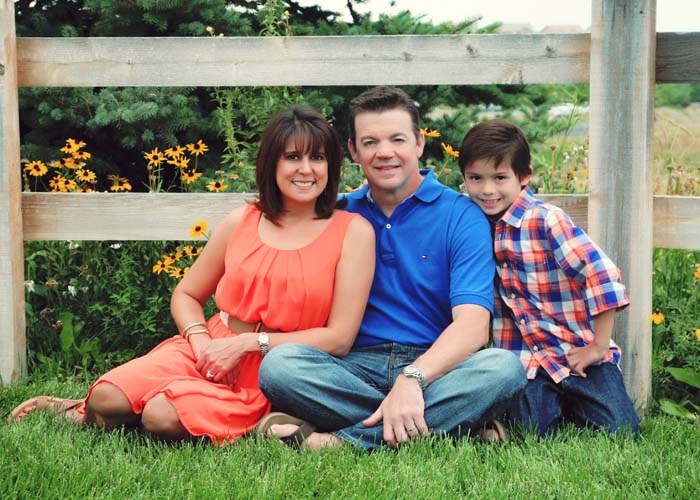 45-family_photos_outdoor_fence_orange_dress_matching_castle_rock_grange.jpg