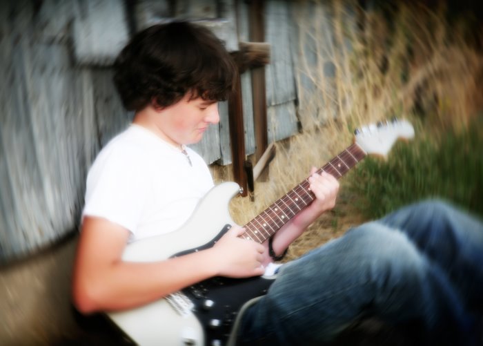 senior_boy_guitar_metal_shed.jpg