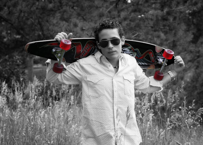 senior_boy_skateboard_meadow.jpg